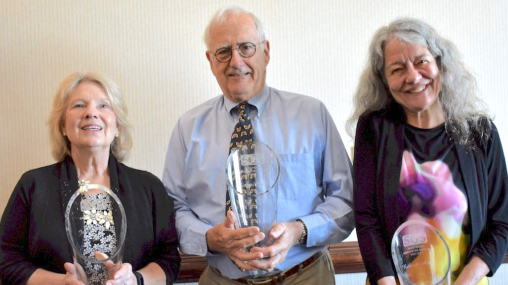 Janice Wassel, Richard Tucker, and Rebecca Adams holding their Gerontology Awards.