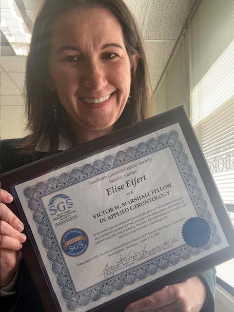 Elise Eifert holding SGS Fellow Certificate in Applied Gerontology.